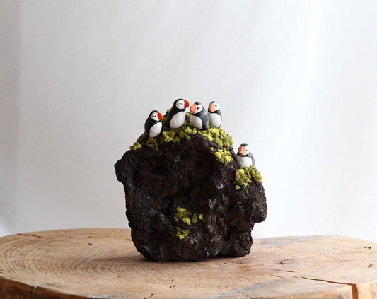 Small Puffins sculptures on a lava rock